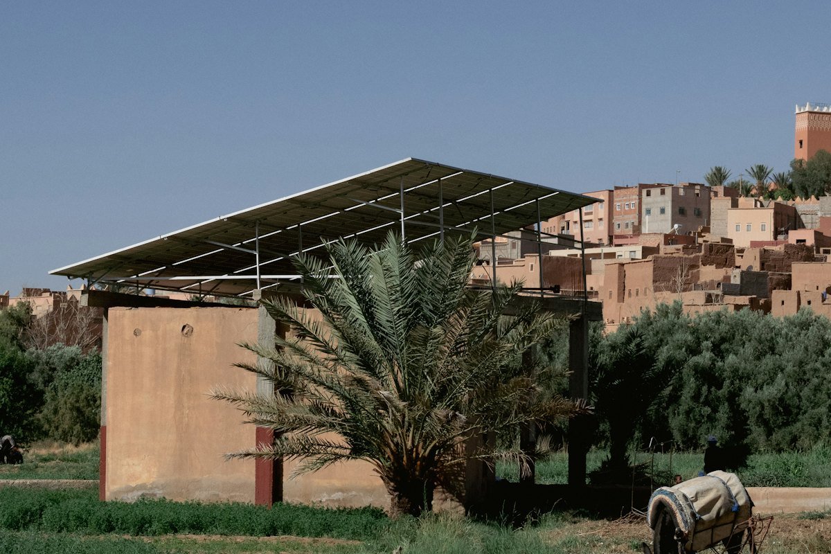 Solar panels on a frame over a rural building
