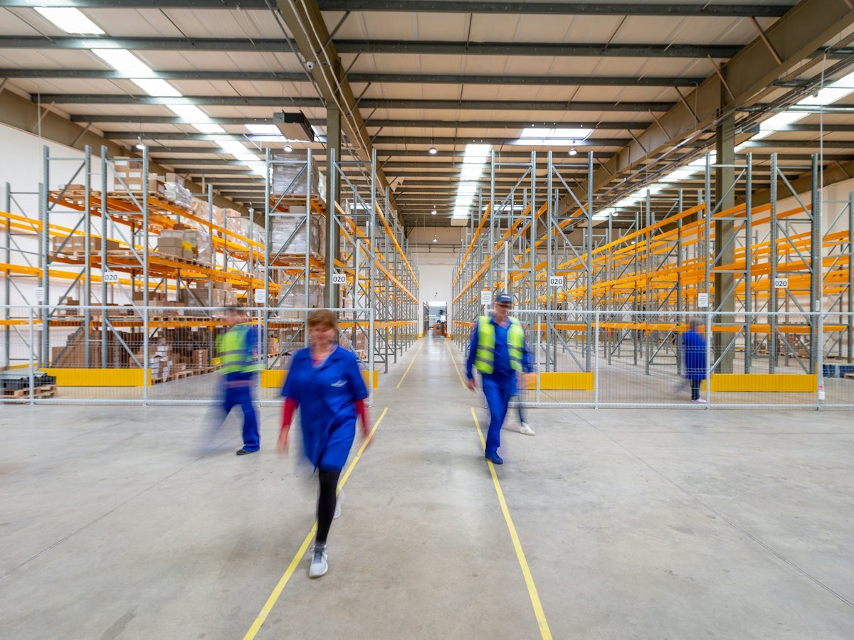 Workers walking through a warehouse aisle